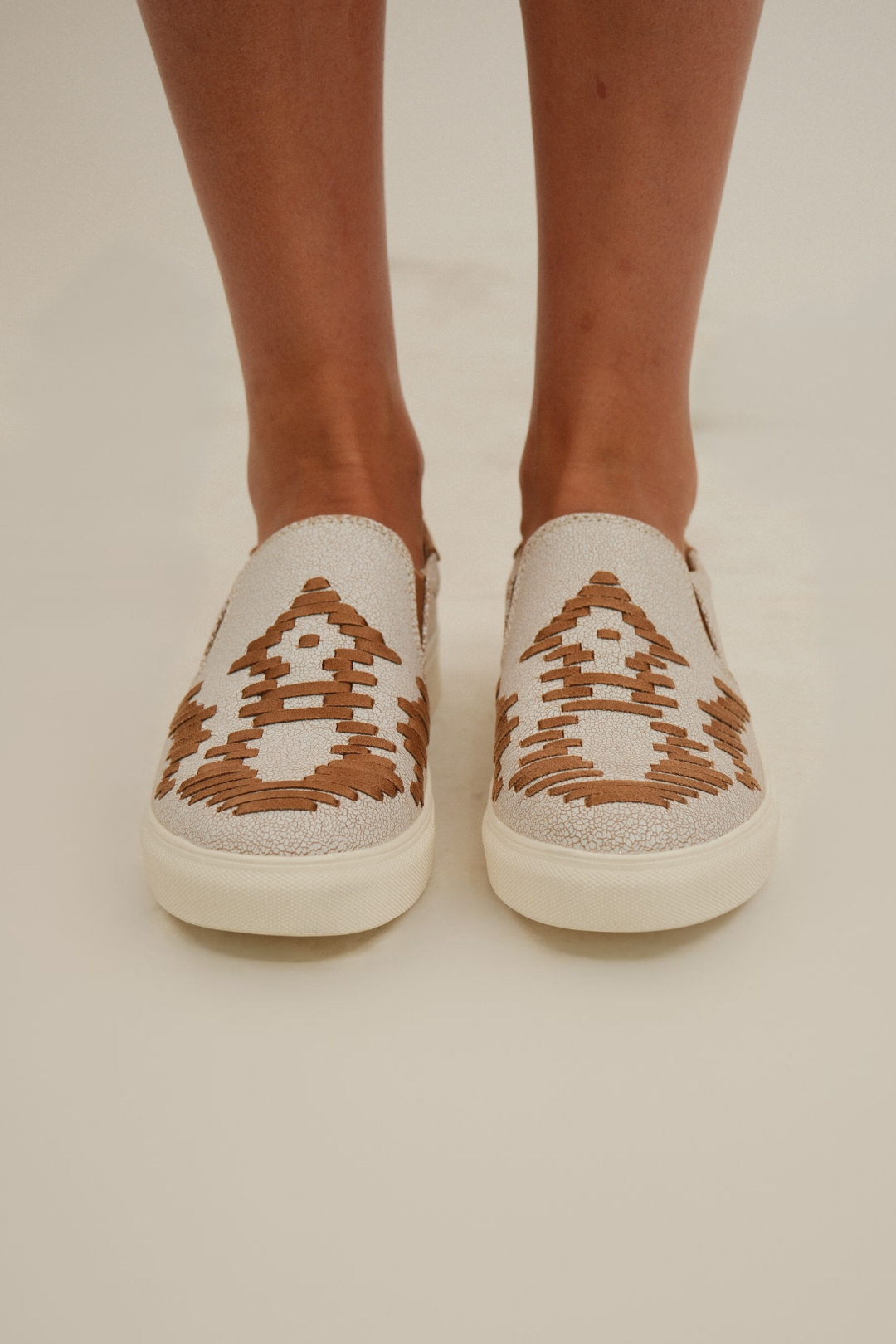 Front view of Rustic Range Slip-On shoes in tan and cream with western embroidery and casual fit.