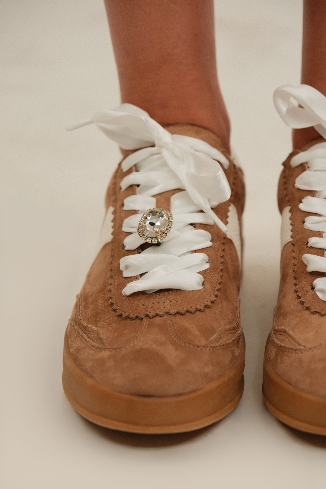 Western-inspired Rodeo Sneakers in brown and cream with gum sole, low-top design, and gemstone lace accent.