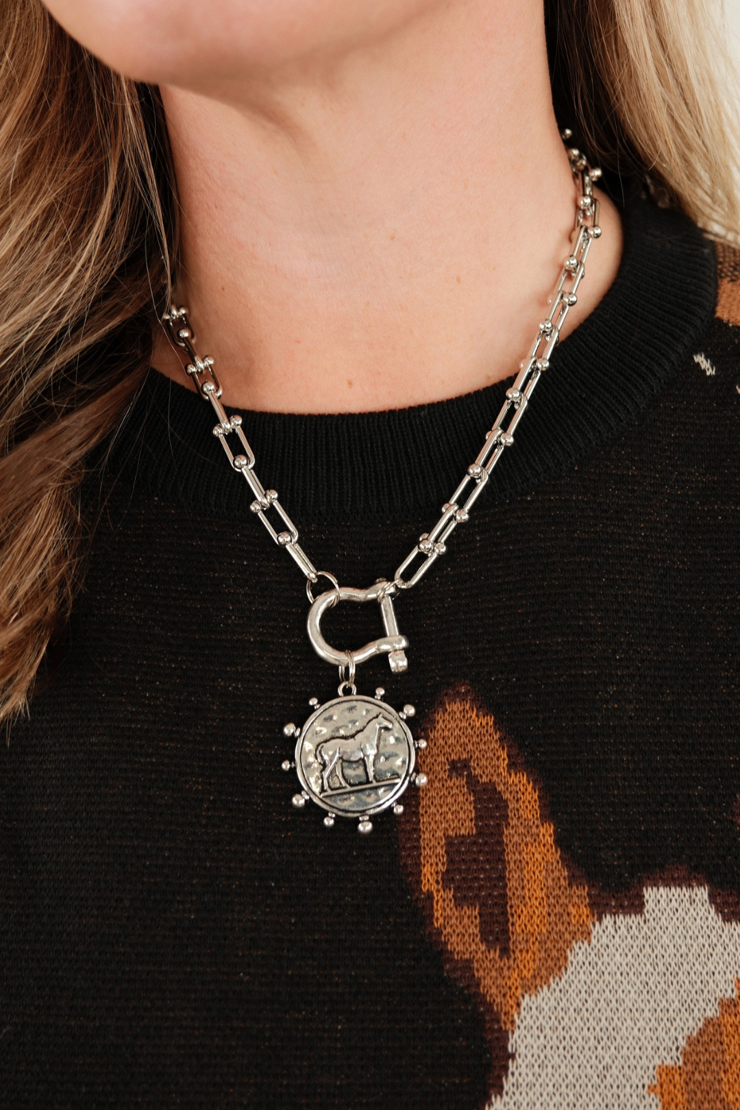 Front view of Bridle Path Pendant Necklace with round horse pendant and stirrup-inspired link chain, classic western jewelry in silver.