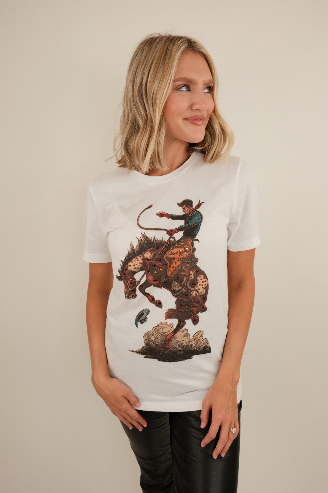 Stone-wash Bronco Dust tee with bold western graphic, relaxed cotton fit (women’s rustic style).