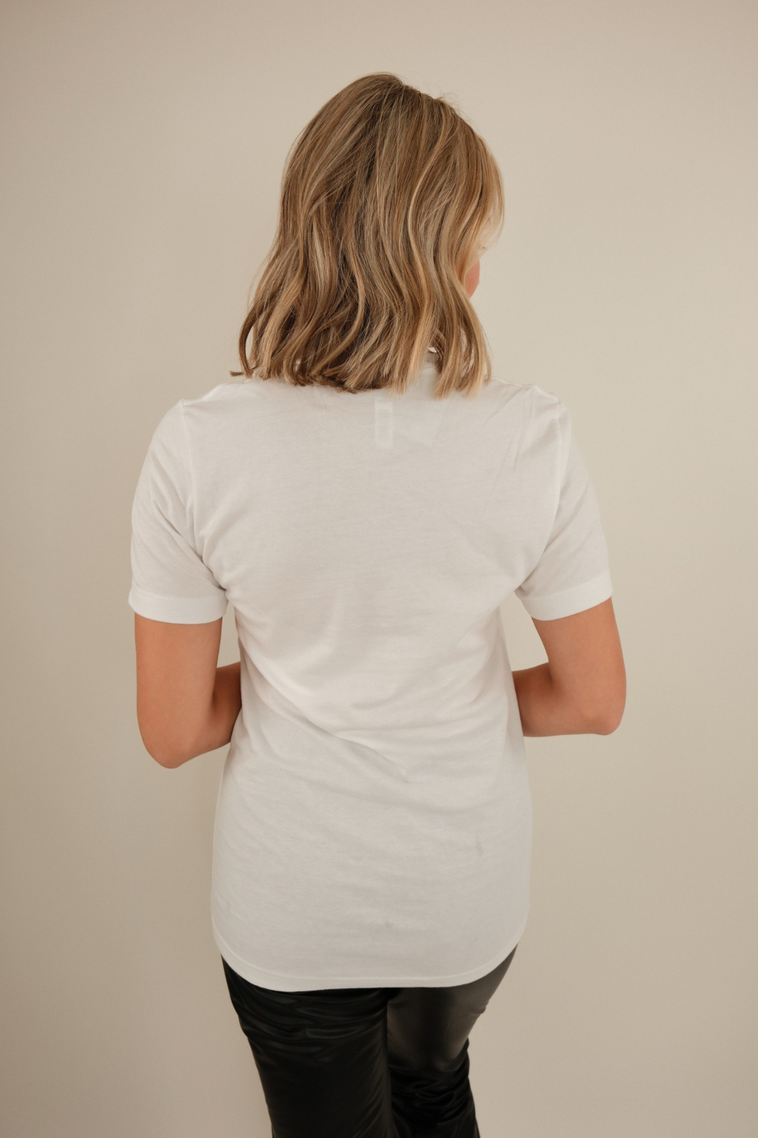 Back view of Bronco Dust Tee in crisp white with plain back and relaxed cowgirl silhouette.
