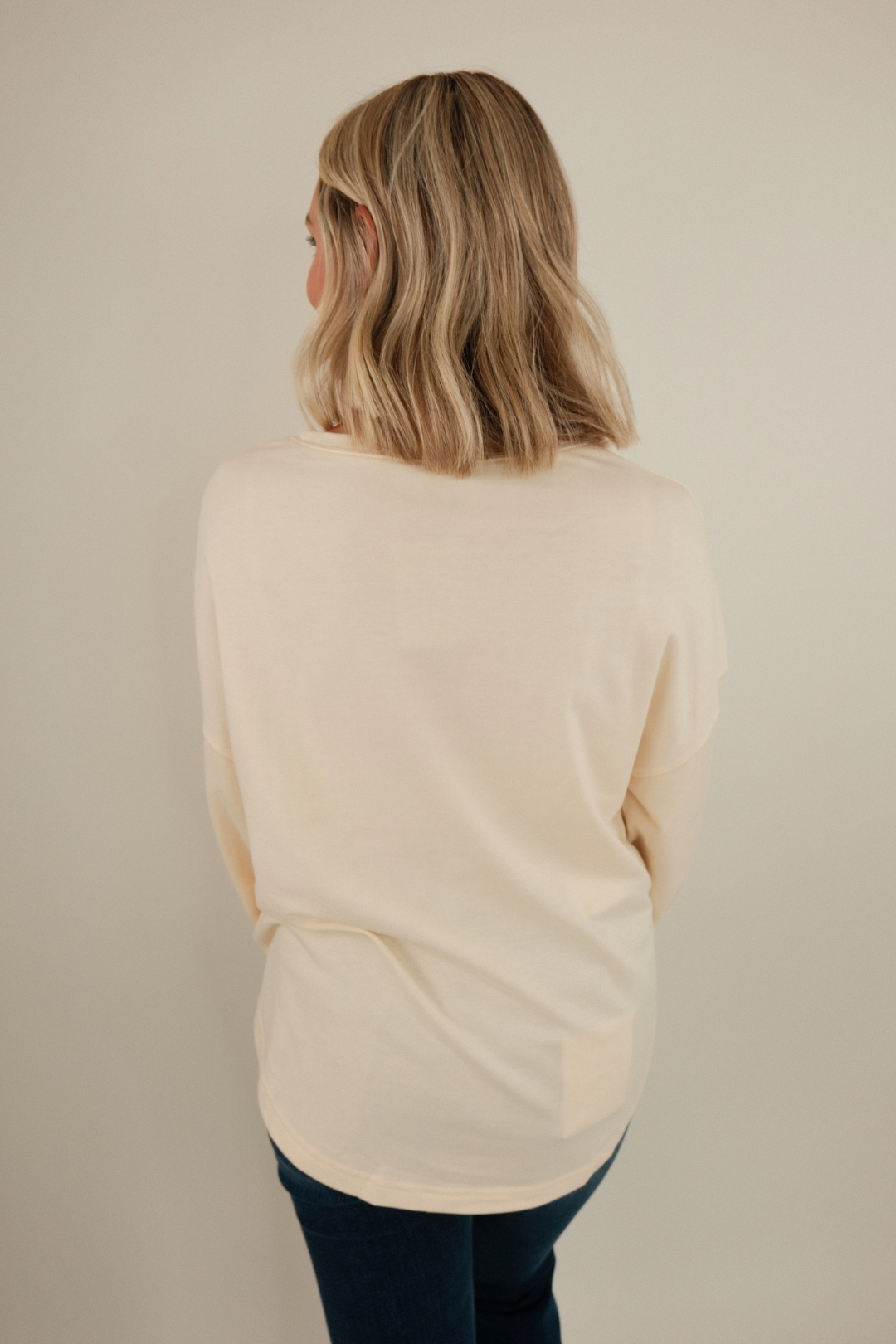 Back view of Bronze Star Pullover in cream knit with brown star motifs and relaxed cowgirl pullover silhouette.
