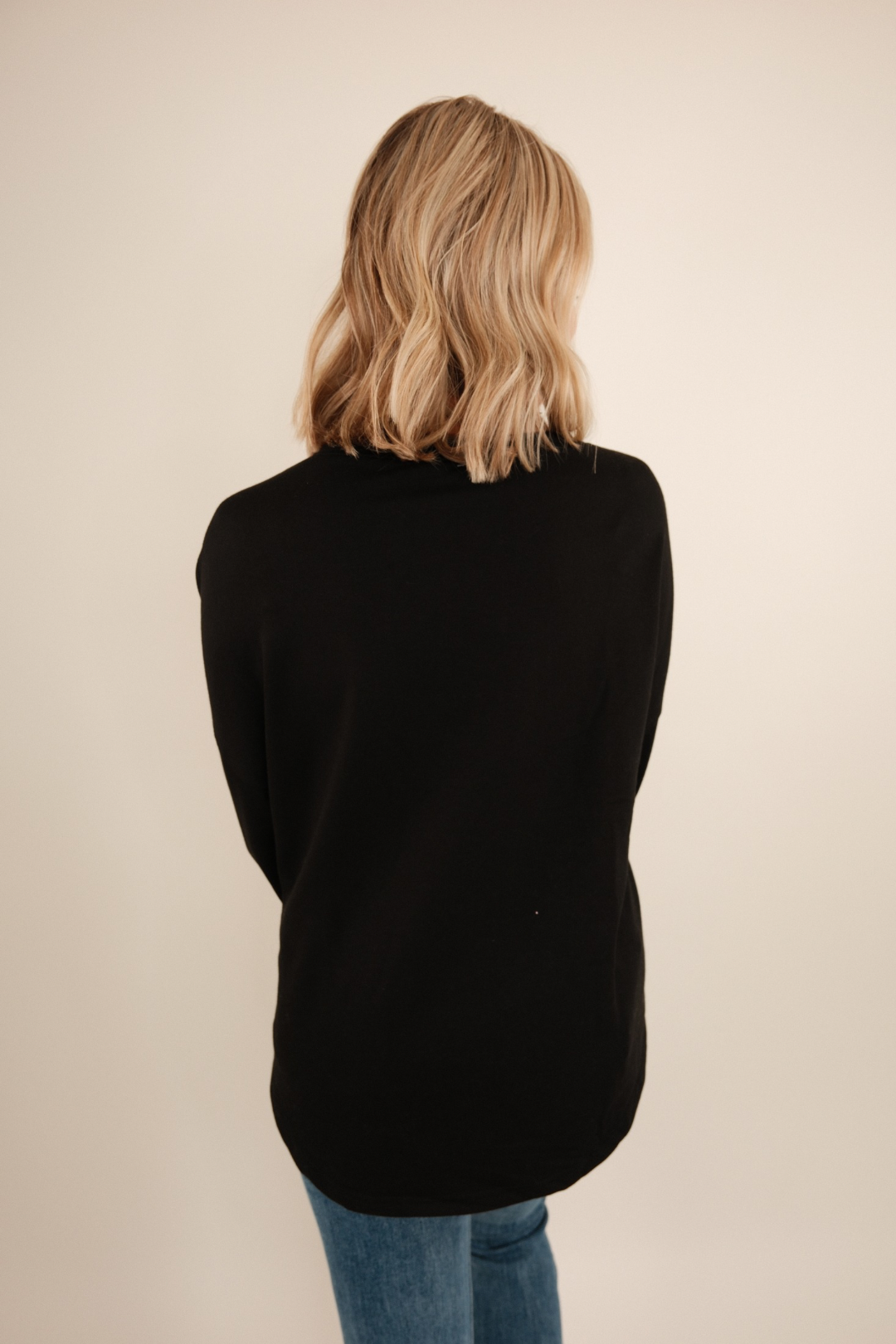 Back view of Bronze Star Pullover in black knit with brown star motifs and relaxed cowgirl pullover silhouette.