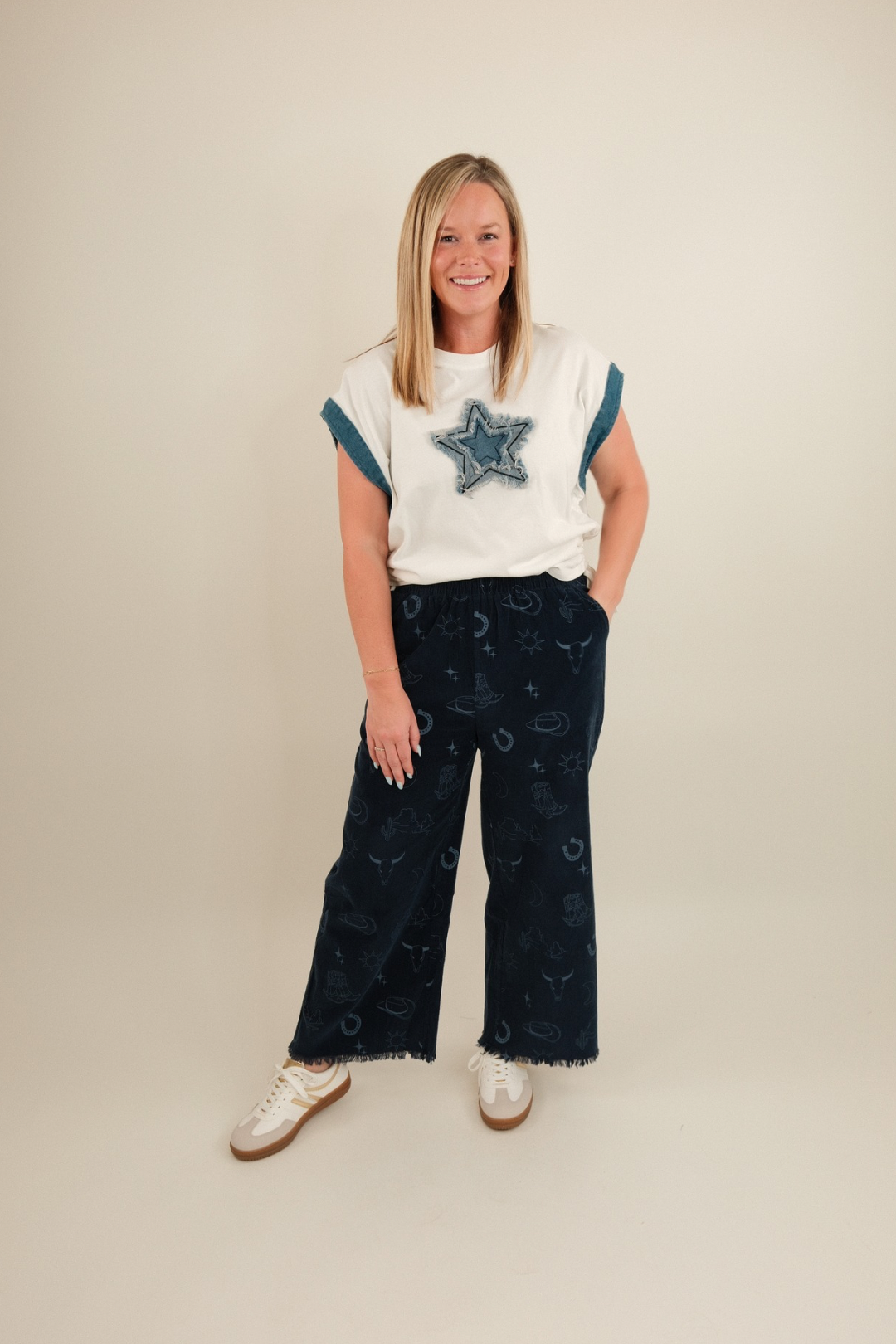 Wide-leg pull-on corduroy pants with western motif print, elastic waistband, roomy pockets in denim blue.