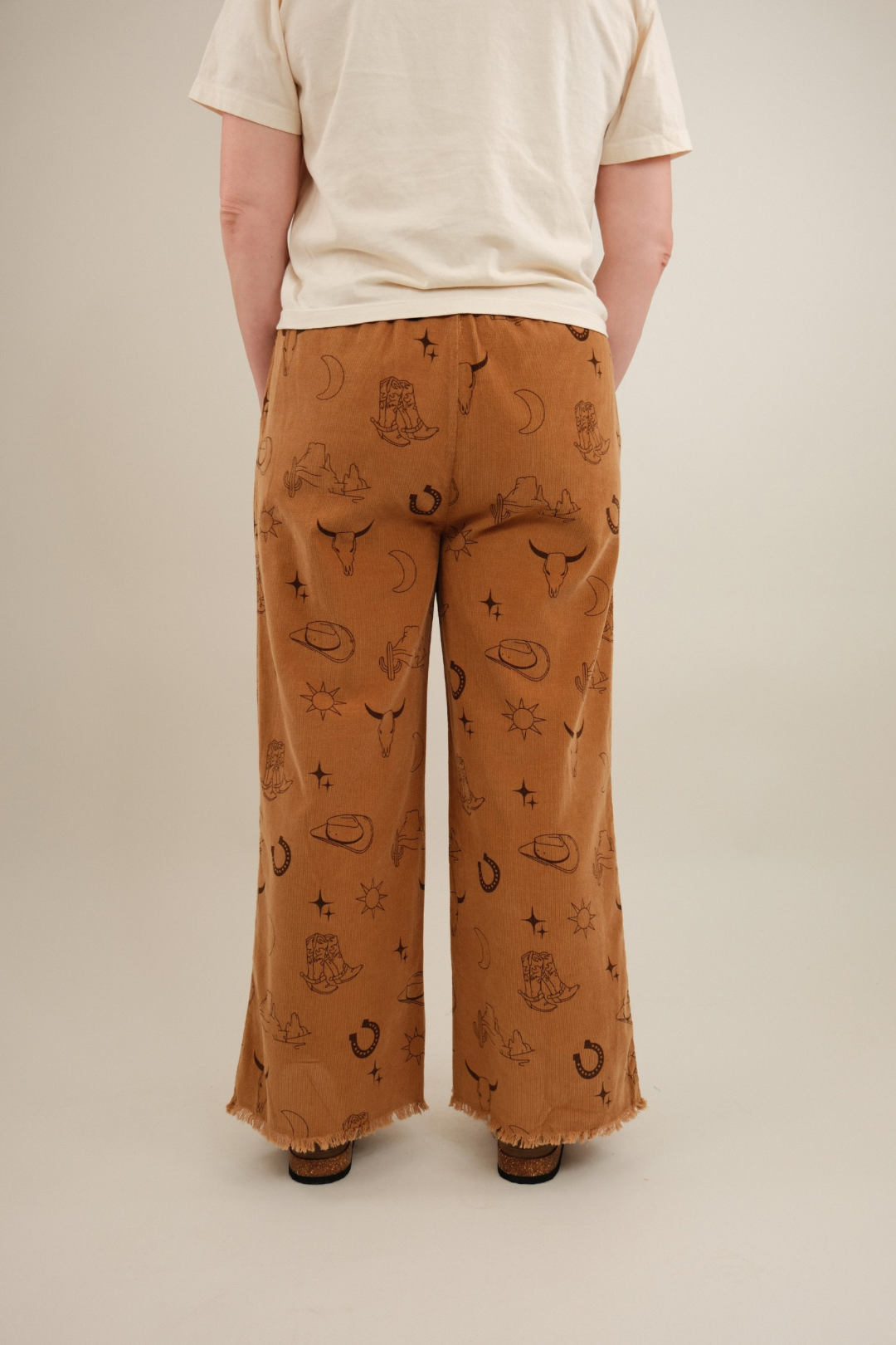 Back view of women’s Canyon Creek Corduroy Pants in camel with elastic waistband, back pockets and wide-leg silhouette.