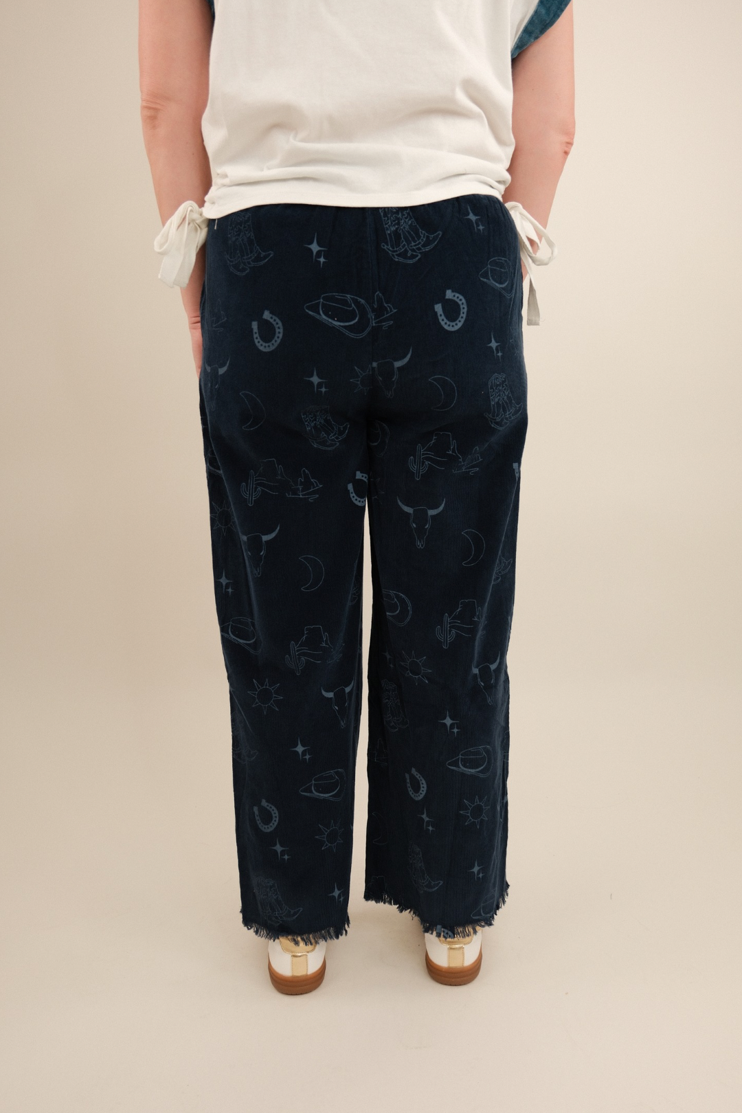 Back view of women’s Canyon Creek Corduroy Pants in denim blue with elastic waistband, back pockets and wide-leg silhouette.