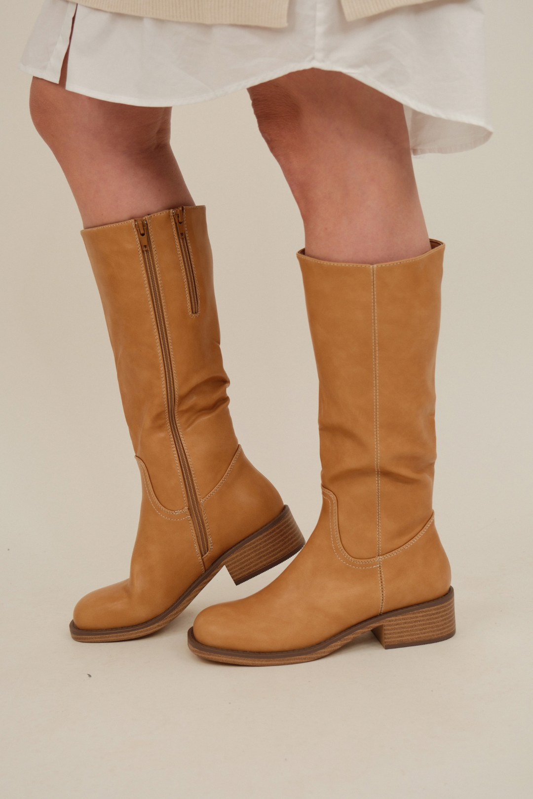 Front view of Canyon Trail Tall Boot in warm camel tan faux leather with rounded toe, stacked heel, and classic western silhouette.