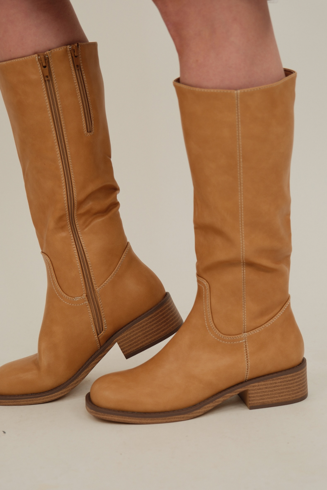 Close-up of Canyon Trail Tall Boot highlighting soft faux leather texture, stacked heel, and smooth western stitching detail.