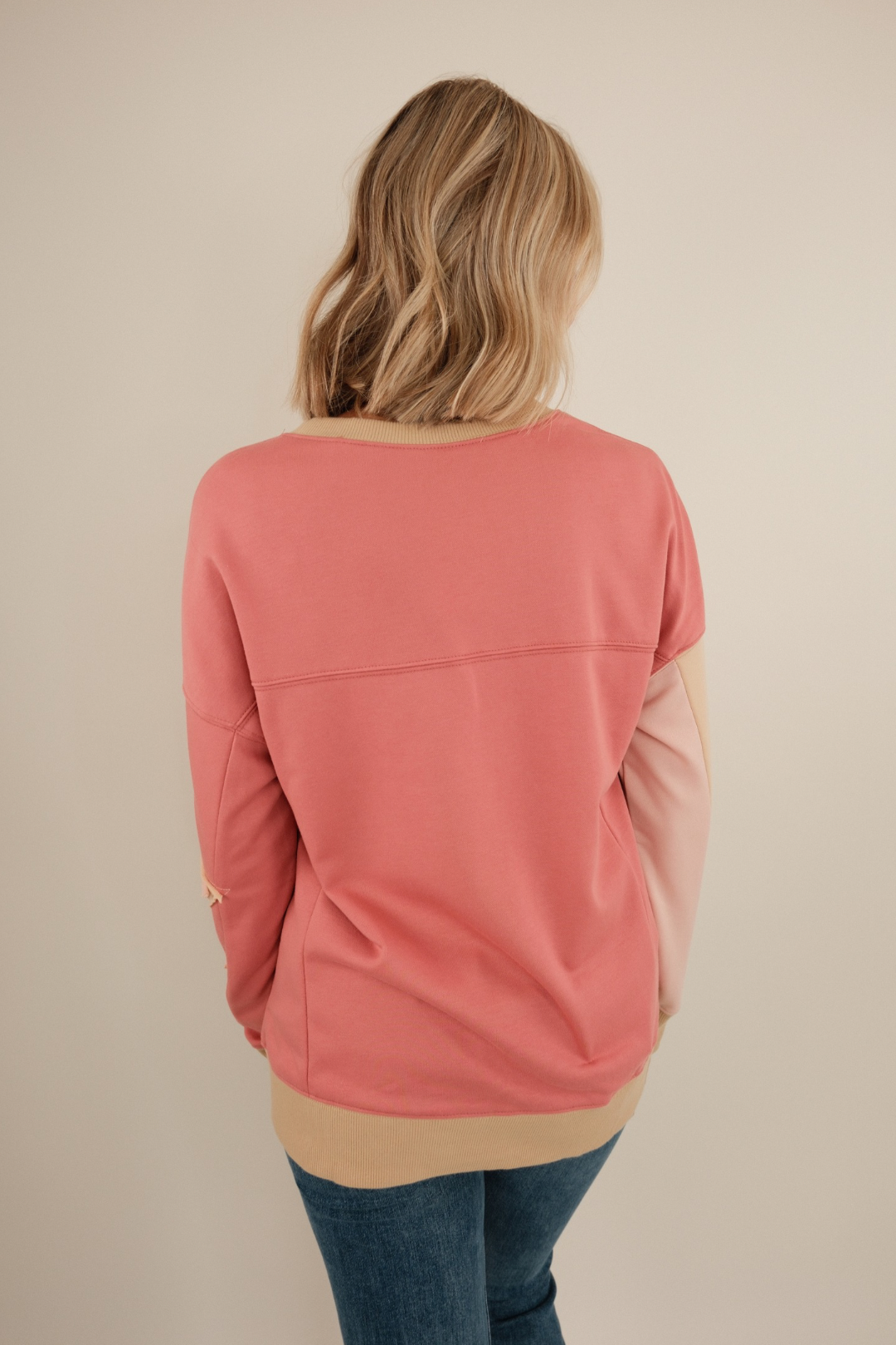 Back view of Cosmic Cowgirl Pullover in rose, lightweight knit with relaxed fit and side slit hem detail.