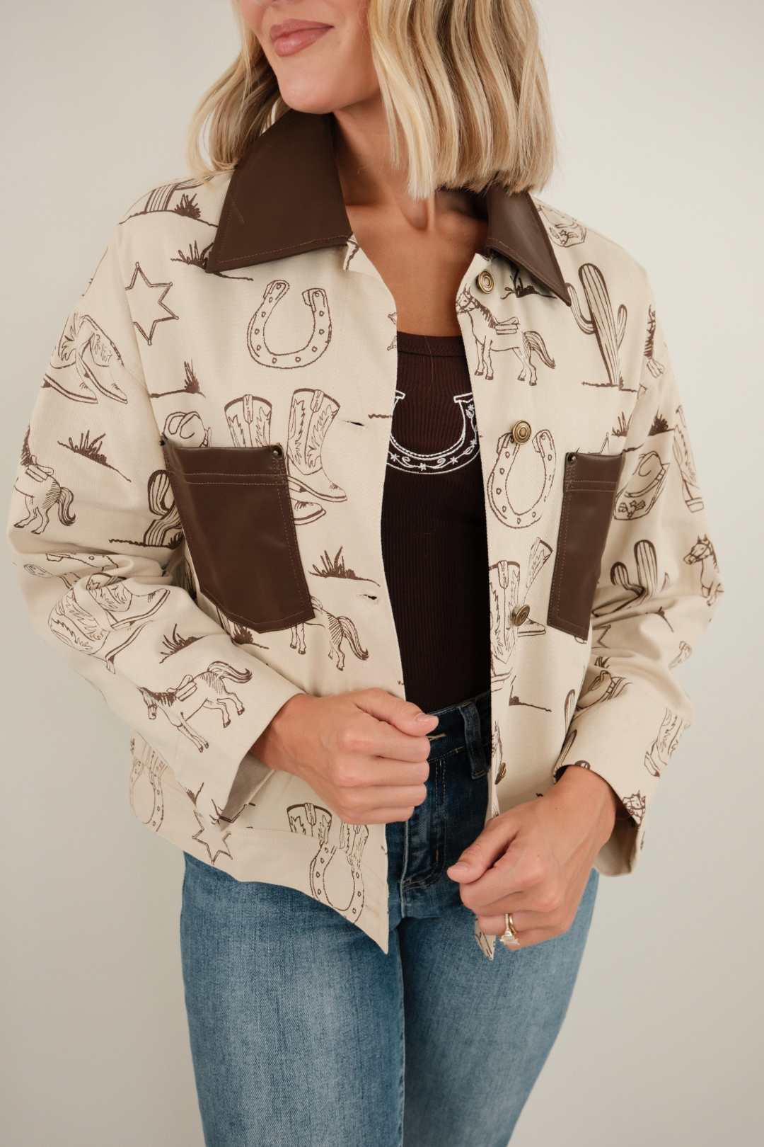 Canvas western jacket with rugged canvas exterior, button-up front, patch pockets and trail-ready styling.