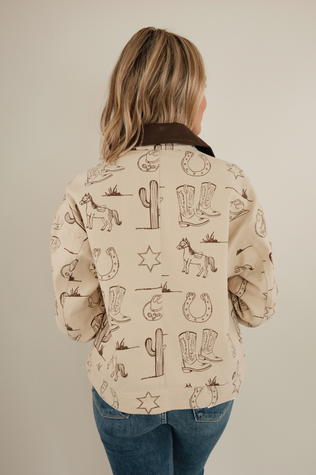 Back view of Cowboy Trails canvas jacket showing structured canvas, yoke seams and western silhouette.