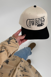 Beige and black cowboy hat with embroidered ‘Put it on my cowboy's tab’ slogan and classic western brim