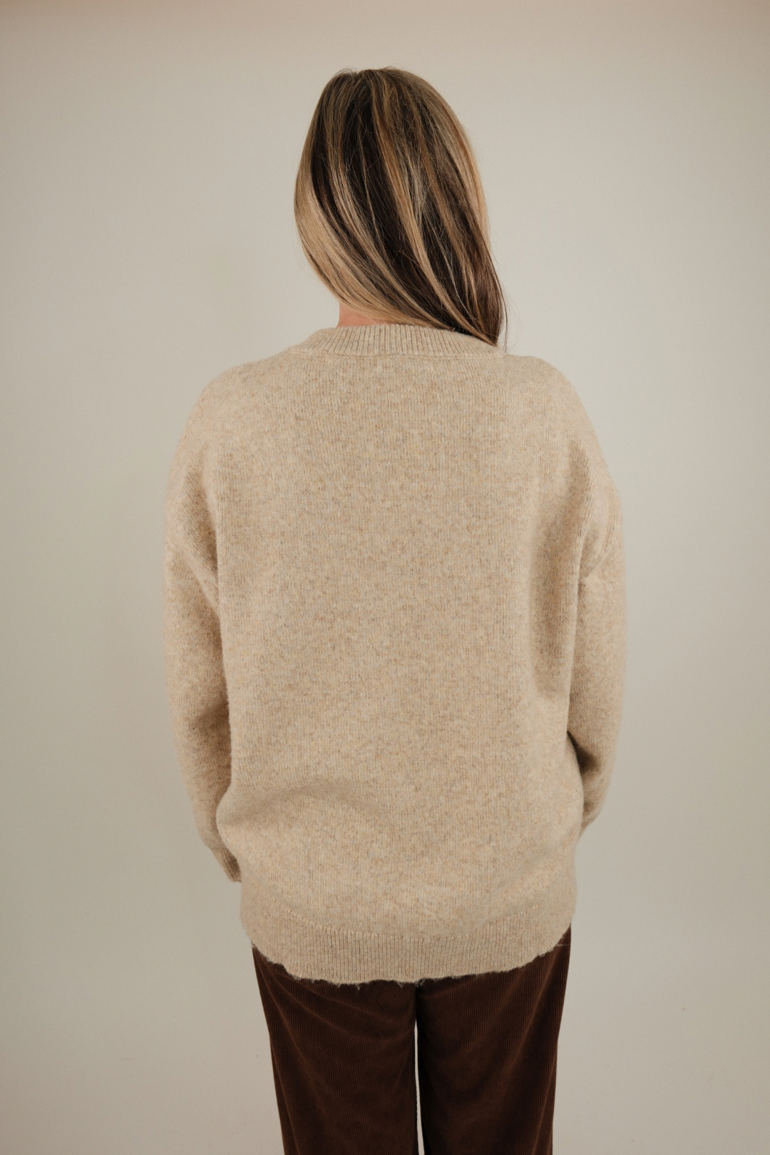 Back view of Cowgirl Classic Sweater, beige knit with medium-weight texture and relaxed silhouette for effortless cowgirl comfort.