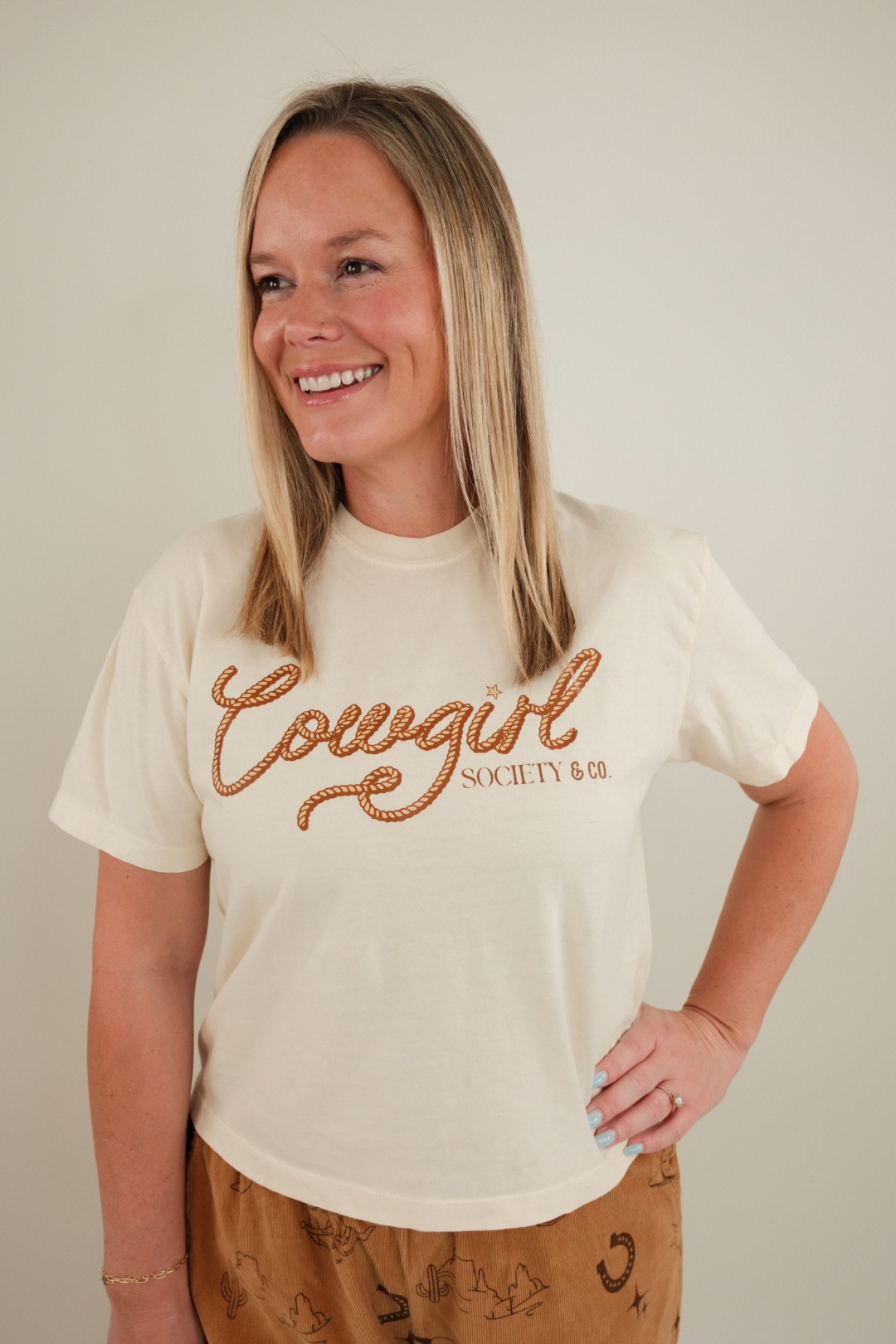 Women’s Cowgirl Connection Cropped Tee in vintage wash with western horseshoe and star graphic, boxy relaxed fit.