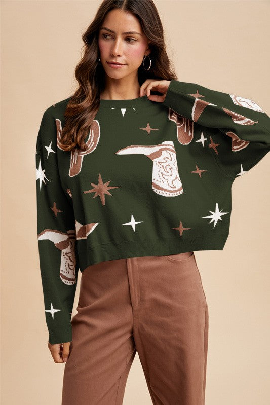 Woman wearing a green sweater with cowboy pattern against a beige background