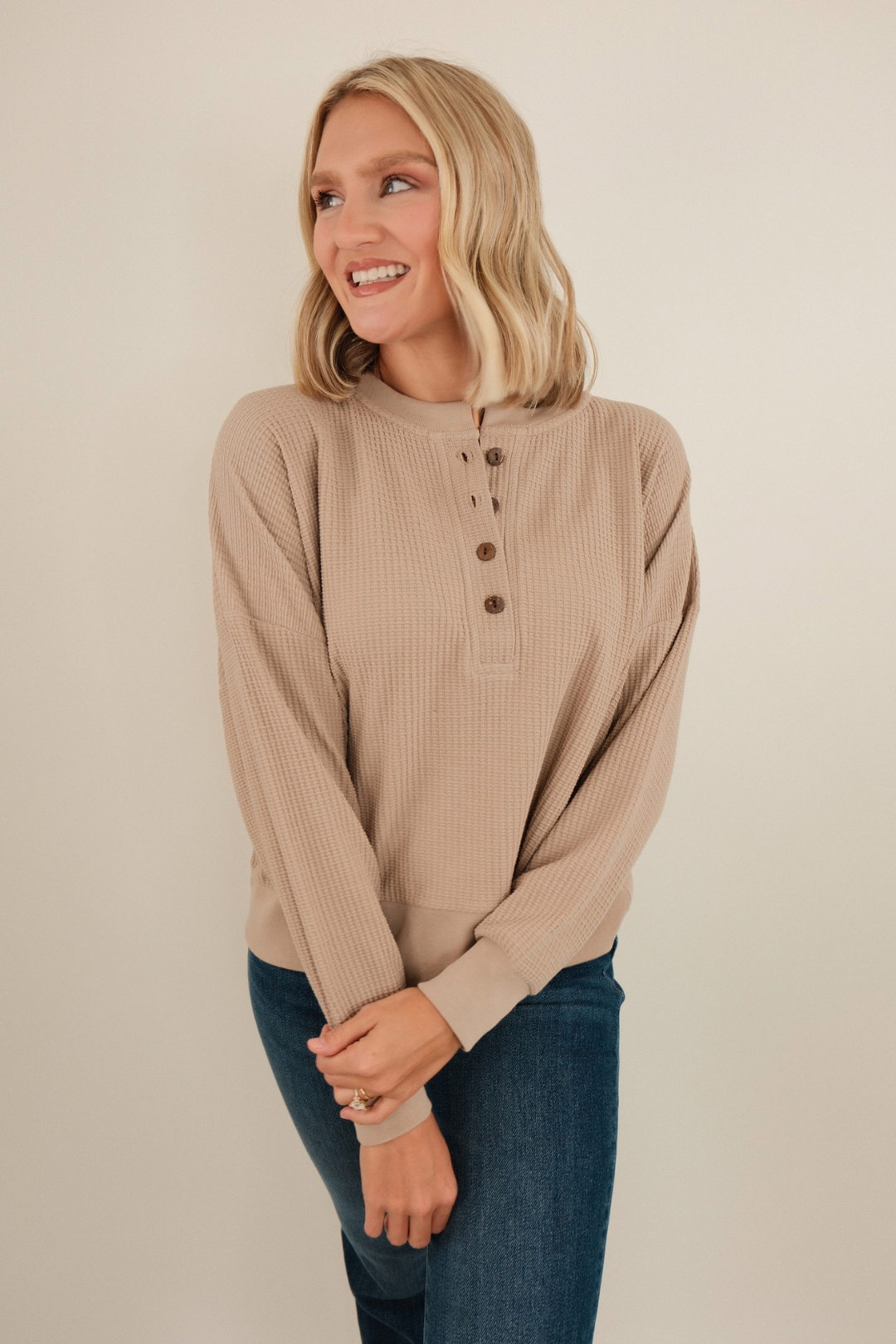 Sand-color waffle knit henley with 5 wooden buttons, long sleeves and relaxed fit — perfect for western layering.