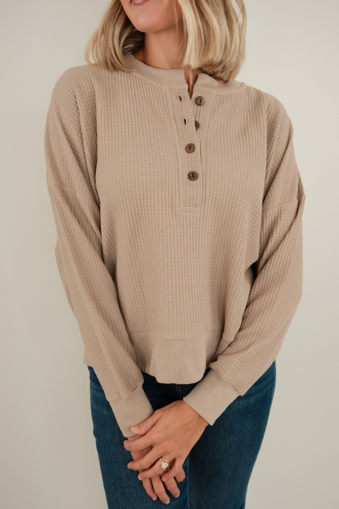 Desert Dune waffle knit henley in sand tone featuring wooden button placket, lightweight texture and long sleeves.