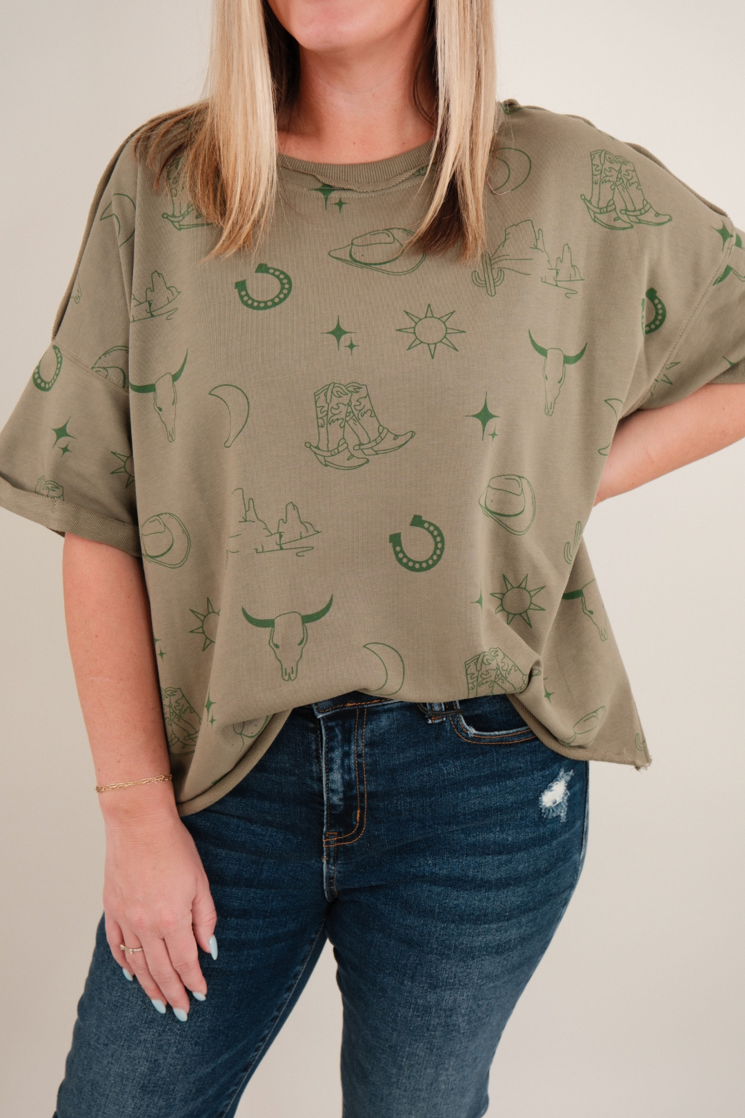 Close-up of women’s Desert Shadows Tee in green showing stone-wash fabric, crew neckline and western graphic detail.