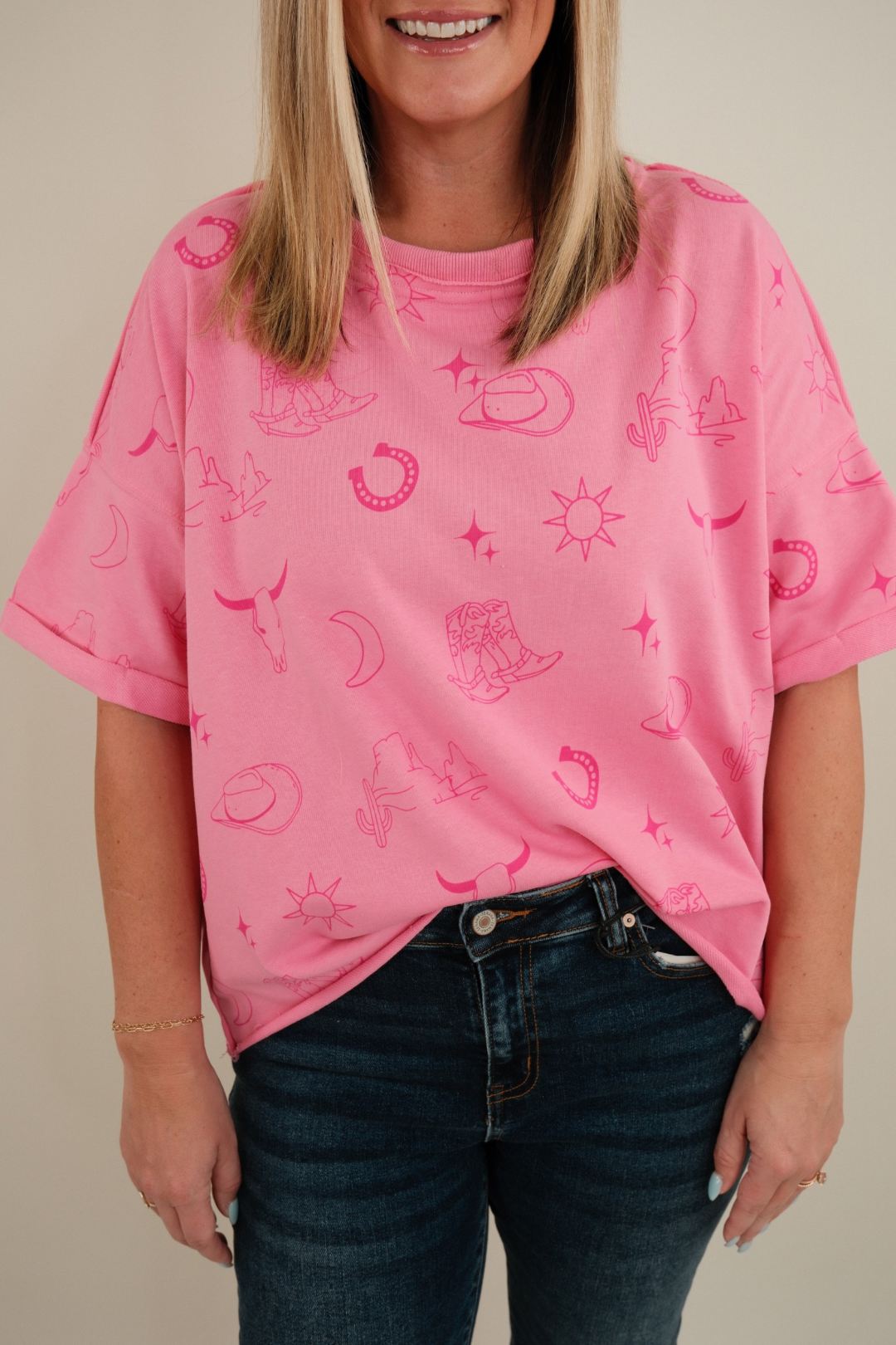 Close-up of women’s Desert Shadows Tee in pink showing stone-wash fabric, crew neckline and western graphic detail.