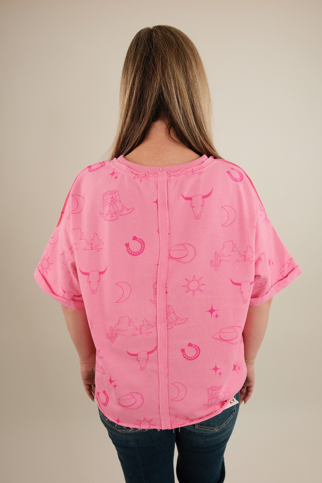 Back view of Desert Shadows Tee in pink, women’s stone-wash cowgirl t-shirt with relaxed western silhouette.
