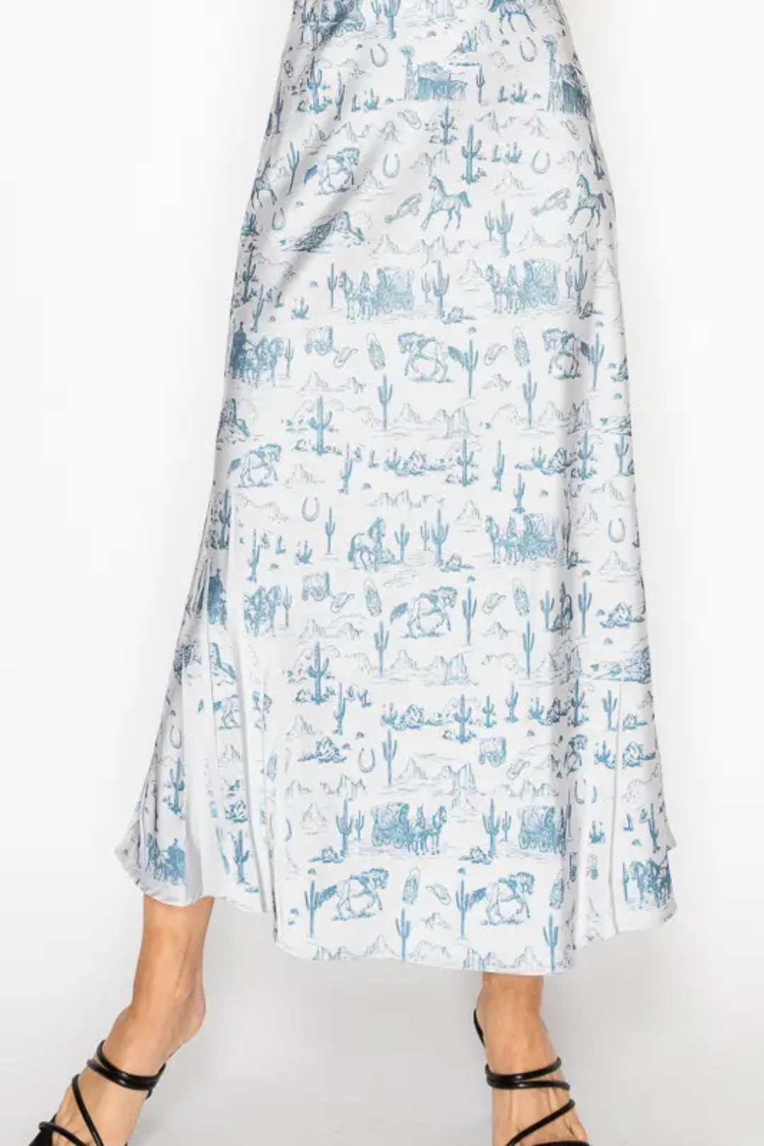 White skirt with blue western pattern worn by a person on a white background