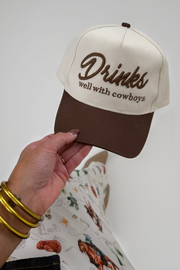 Beige and brown hat with embroidered ‘Drinks well with cowboys’ slogan and classic western brim