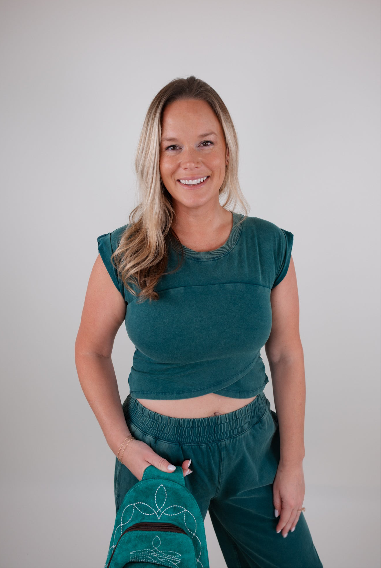 Woman wearing a green outfit set with a plain background
