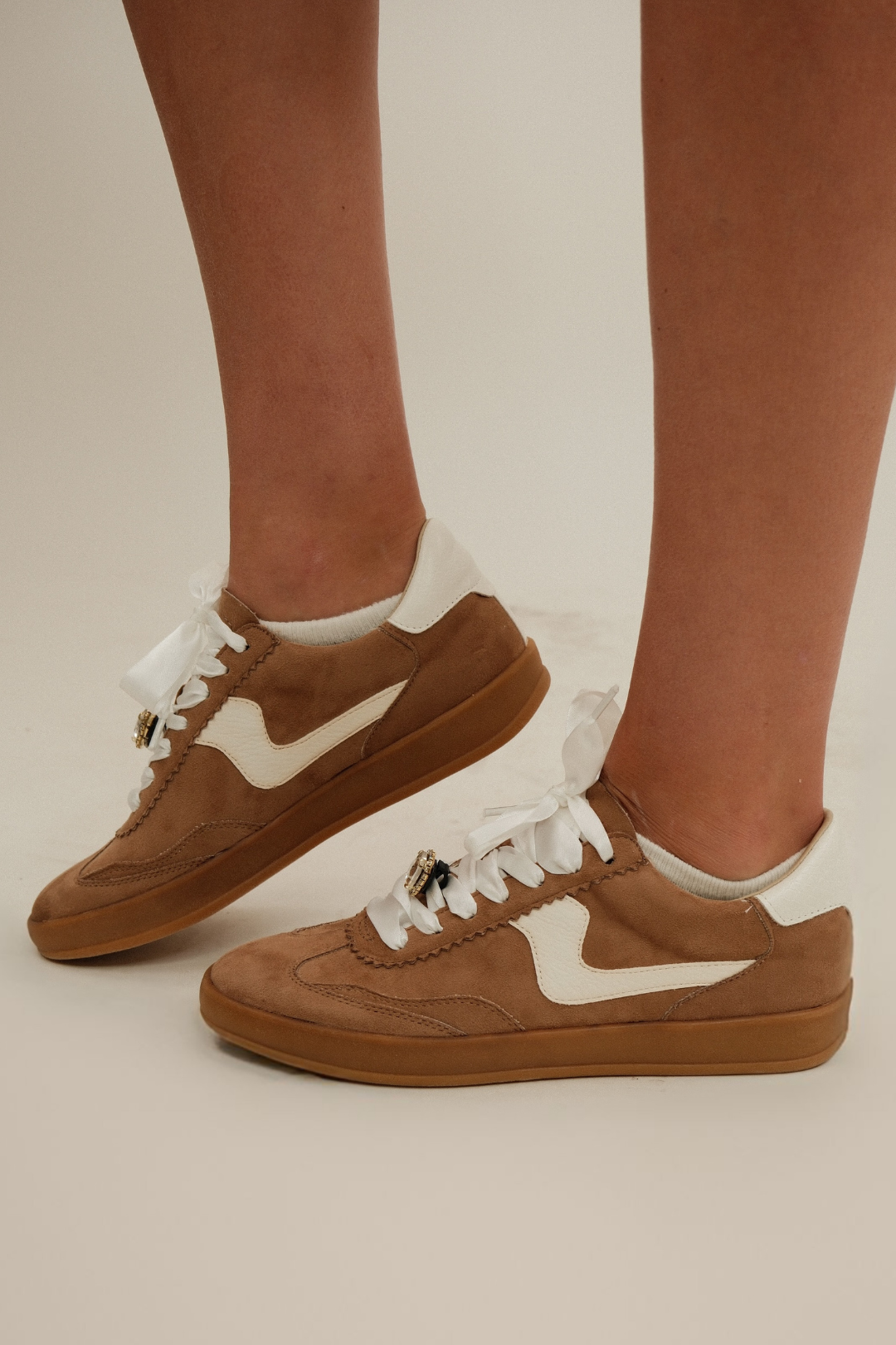 Side profile of Rodeo Sneakers showing cream side detail, brown T-toe, low silhouette and gum sole.