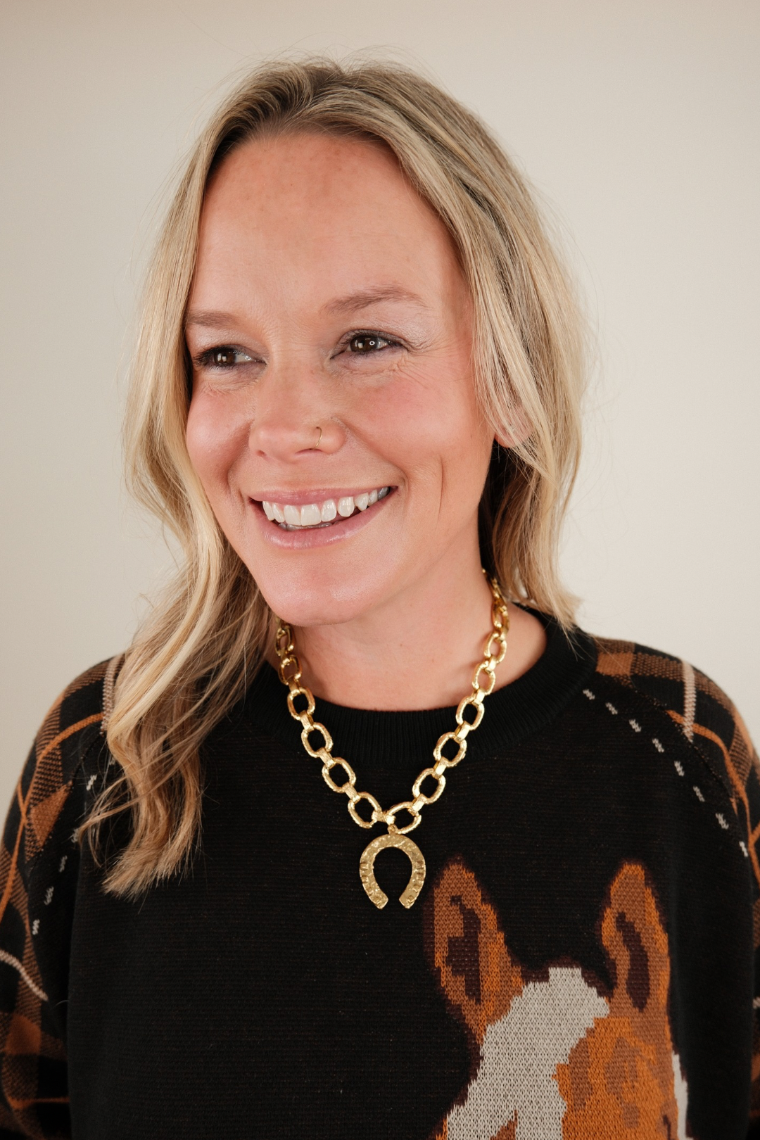 Golden Luck Link Necklace with gold horseshoe pendant and textured gold chain — elegant cowgirl jewelry with western flair.