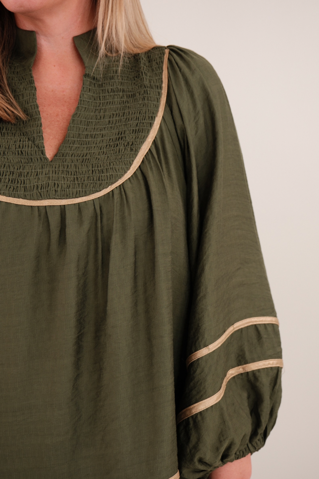 Side profile of Golden Mesa Blouse showing soft drape, golden fabric and relaxed western silhouette.