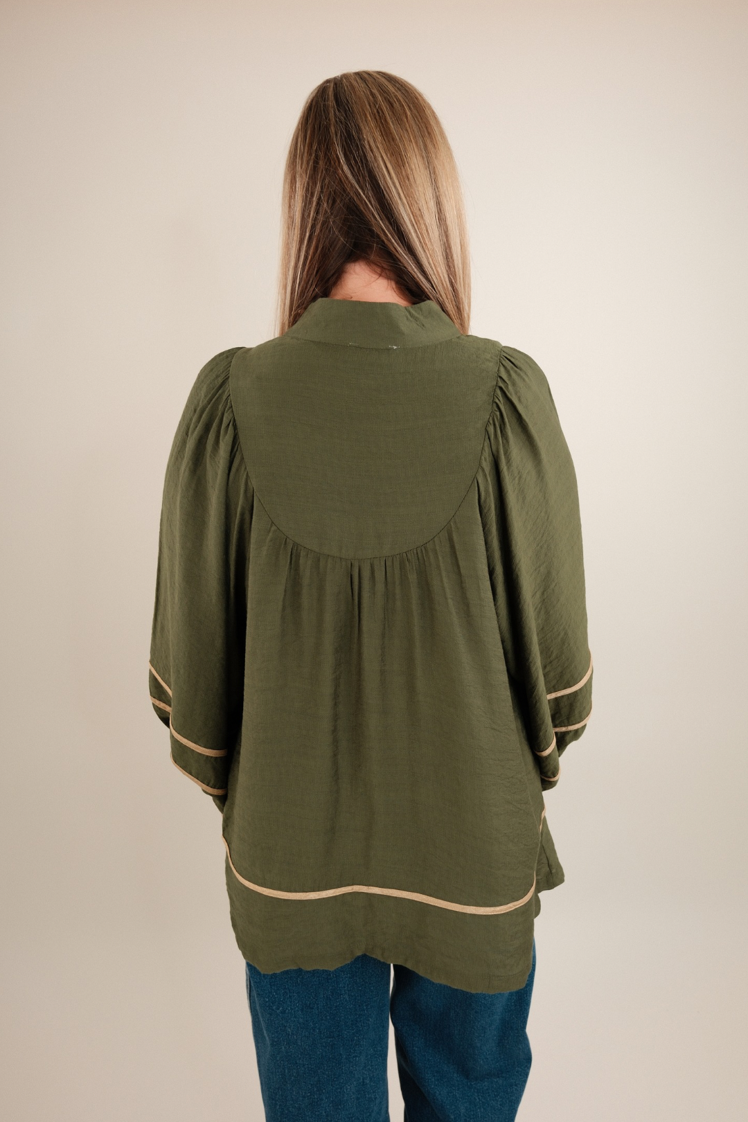 Back view of Golden Mesa Blouse in rustic gold with clean lines and subtle embroidered detail.