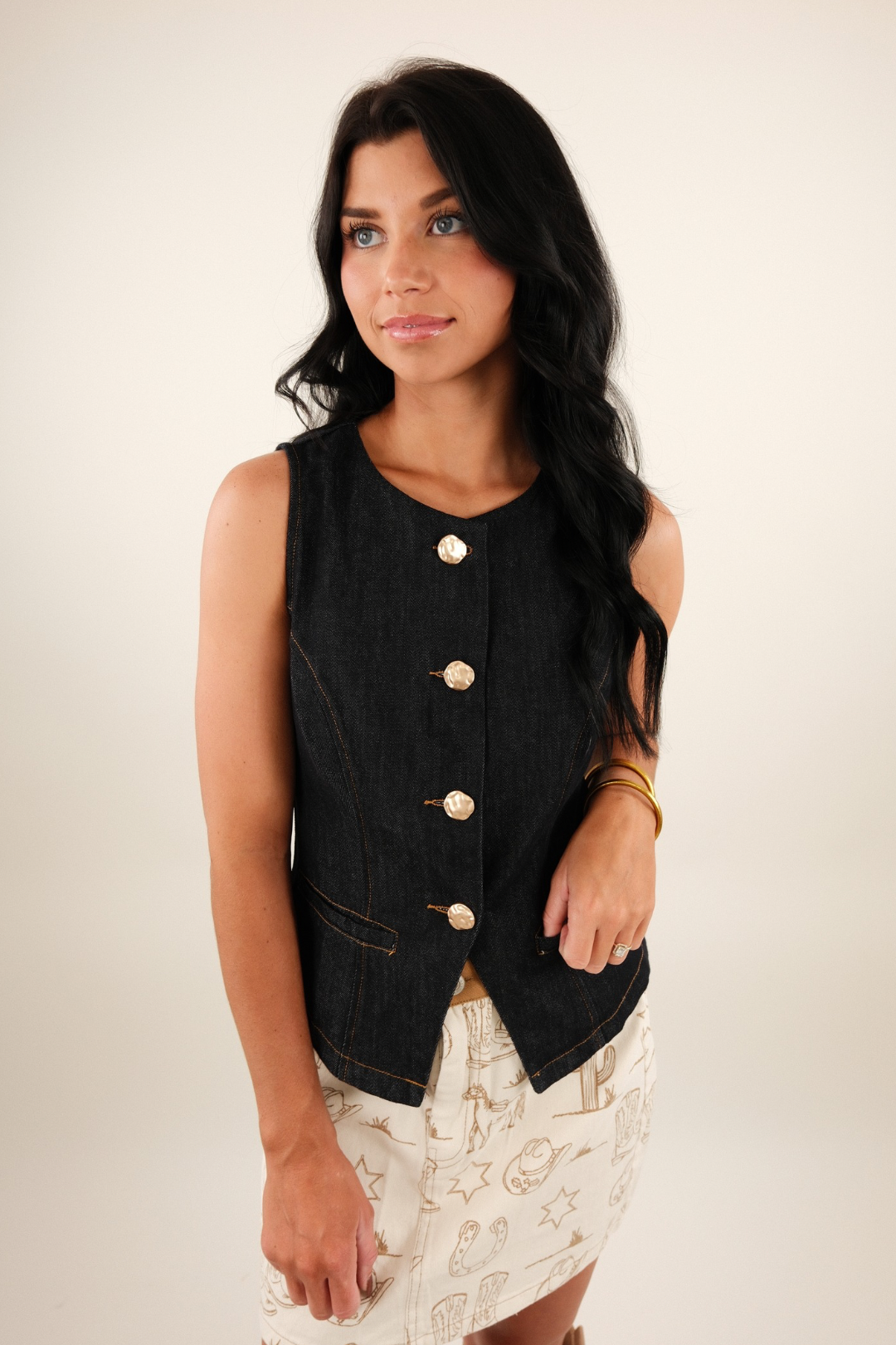 Front view of Golden Range Denim Vest in dark wash denim with brushed gold buttons, darted seams and front pockets for a refined western look.