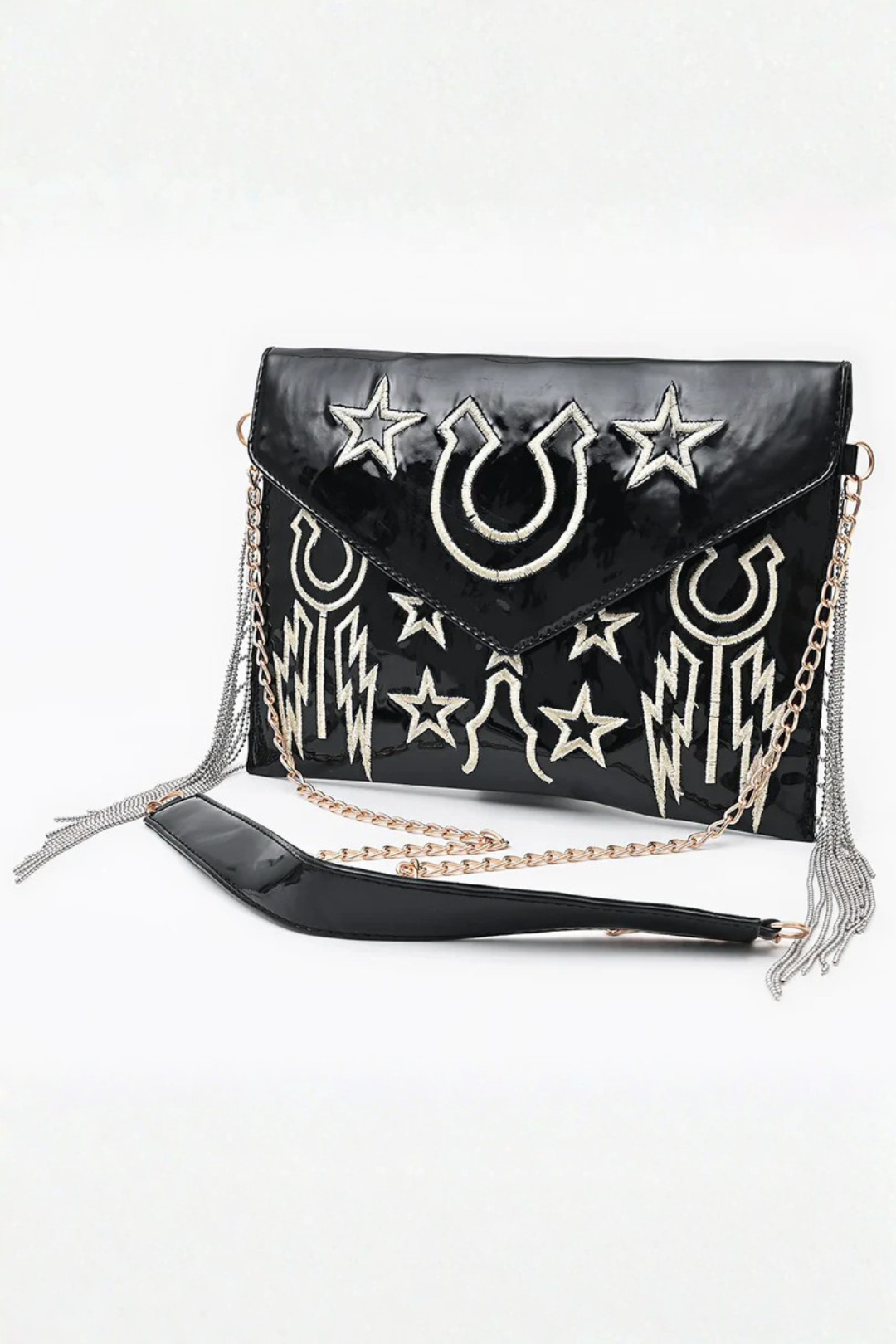 Black handbag with star and horseshoe embroidered designs on a white background