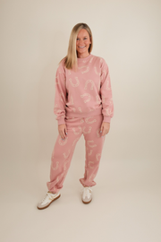 Front view of Horseshoe Haven Lounge Set in light mauve with cream horseshoe print, pullover sweatshirt and high-waisted joggers.