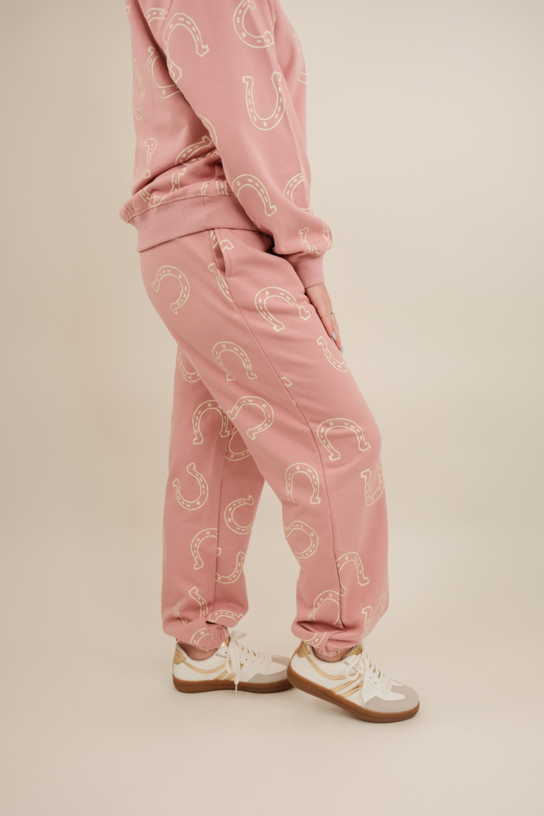 Side profile of Horseshoe Haven Lounge Set showing relaxed pullover and drawstring joggers with cream horseshoe design.