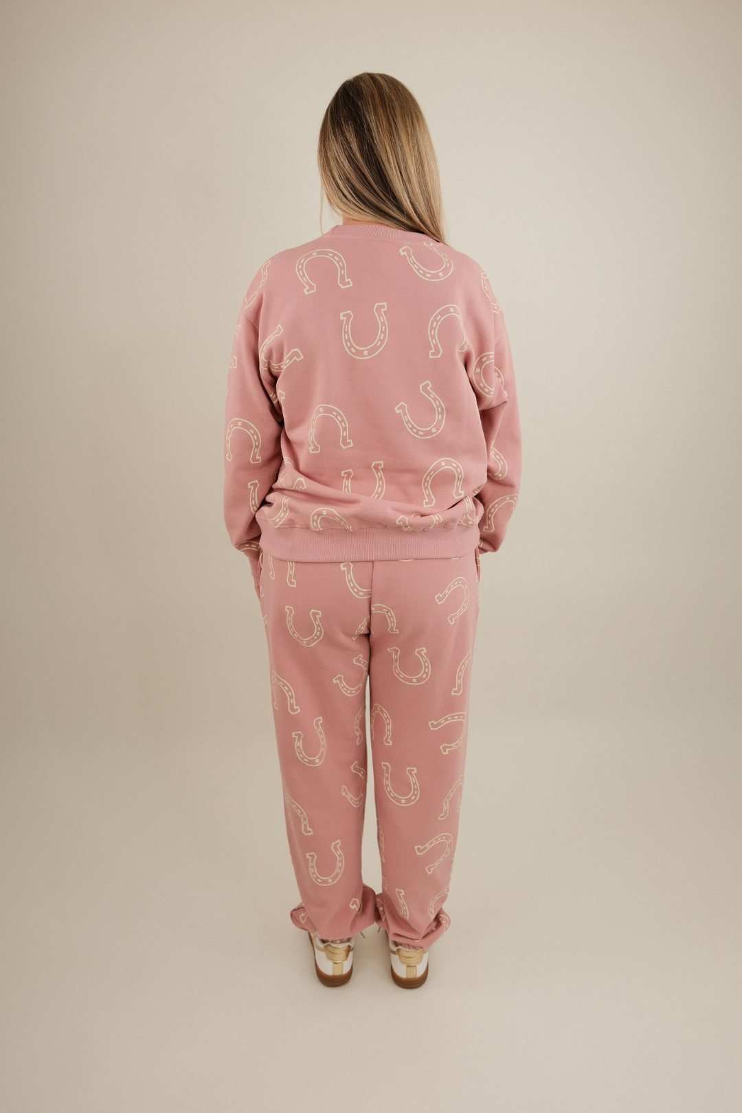 Back view of Horseshoe Haven Lounge Set in light mauve with cream horseshoe print across sweatshirt and joggers.