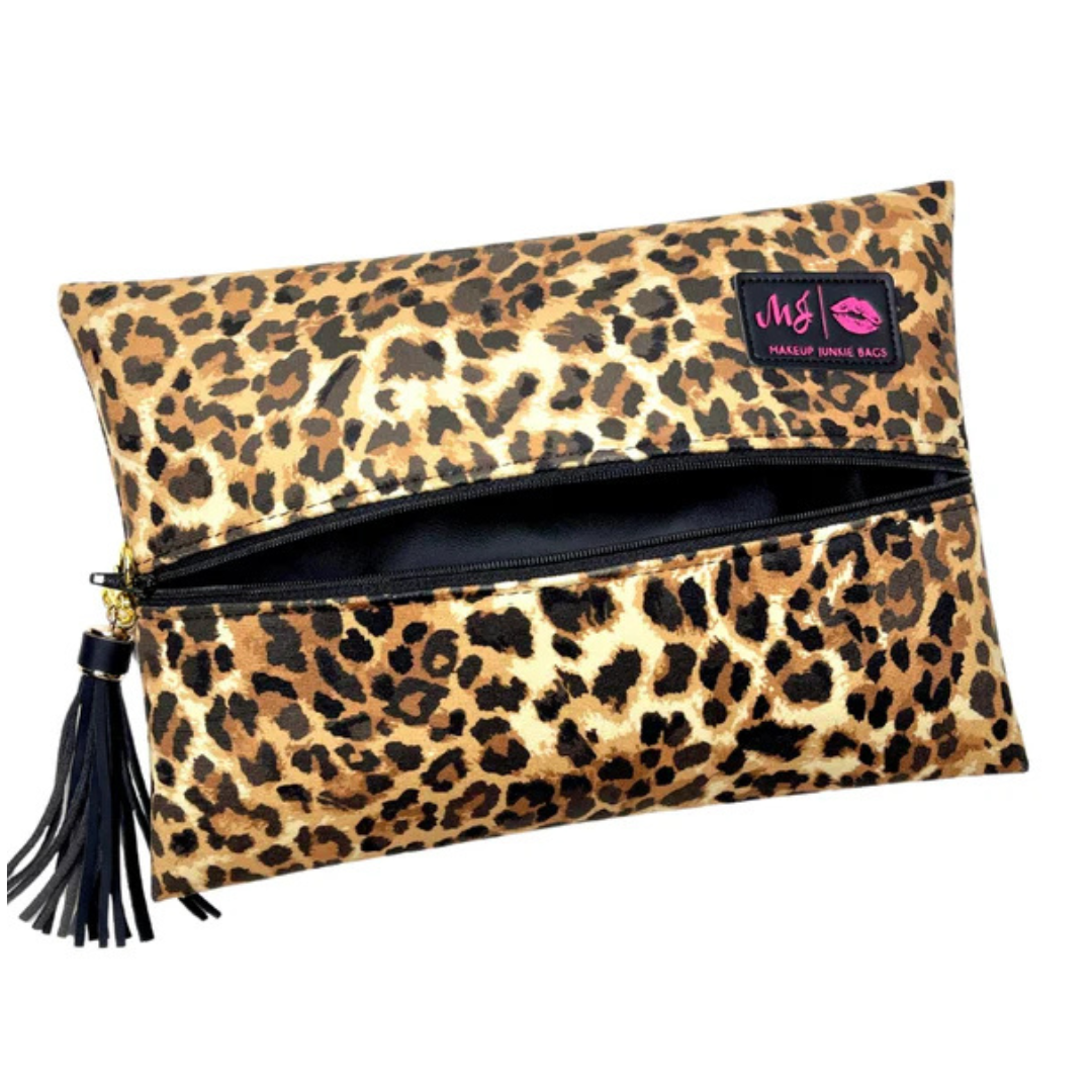 Front view of Lady Leopard Makeup Junkie bag with cream velvet back and bold black leopard spots, plus clear front panel for visibility.