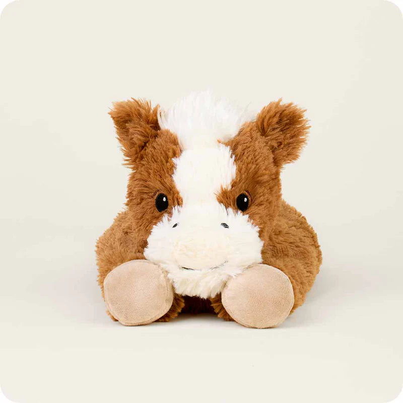 Laying Down Horse Warmies Plush displayed on blanket, microwavable plush deer offering warmth, lavender scent, and soothing comfort.