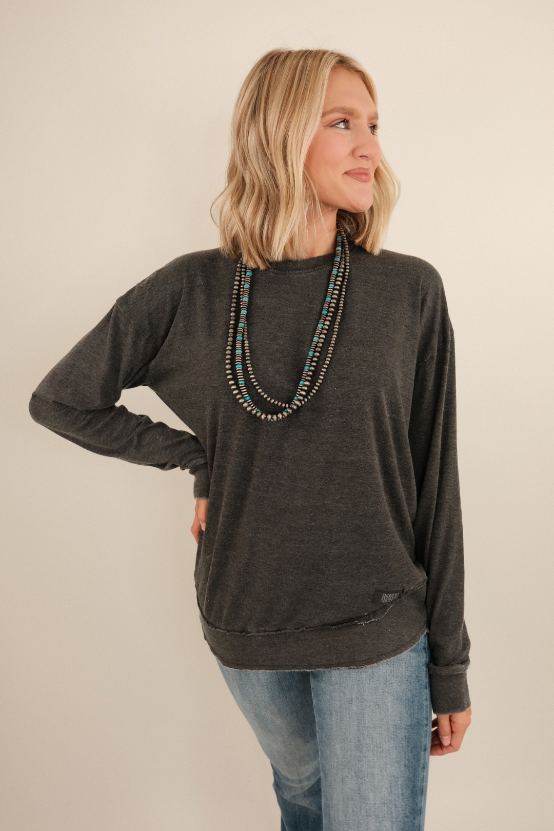 Vintage-washed long sleeve poncho tee in charcoal with relaxed drape and western flair.