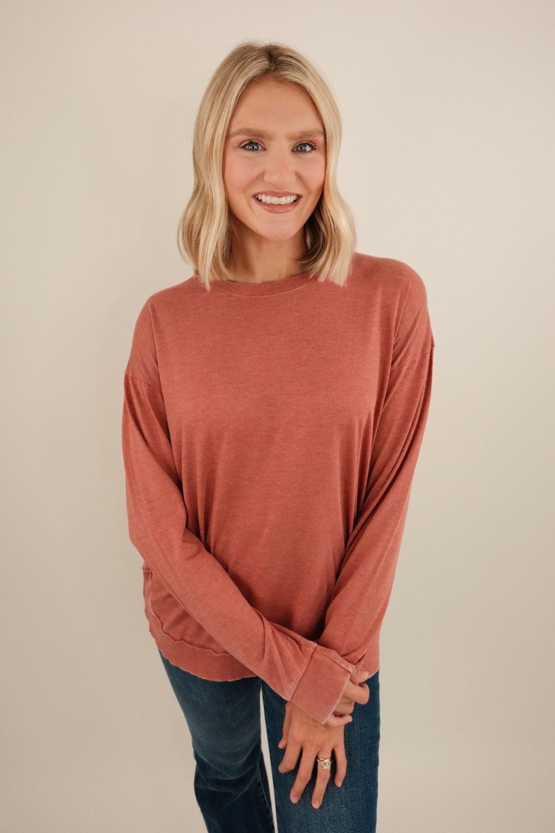Vintage-washed long sleeve poncho tee in brick with relaxed drape and western flair.