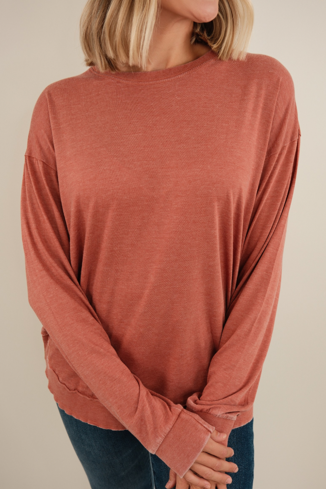 Close-up of Vintage Washed Poncho Tee highlighting brick fabric, vintage wash texture and poncho sleeve detail.