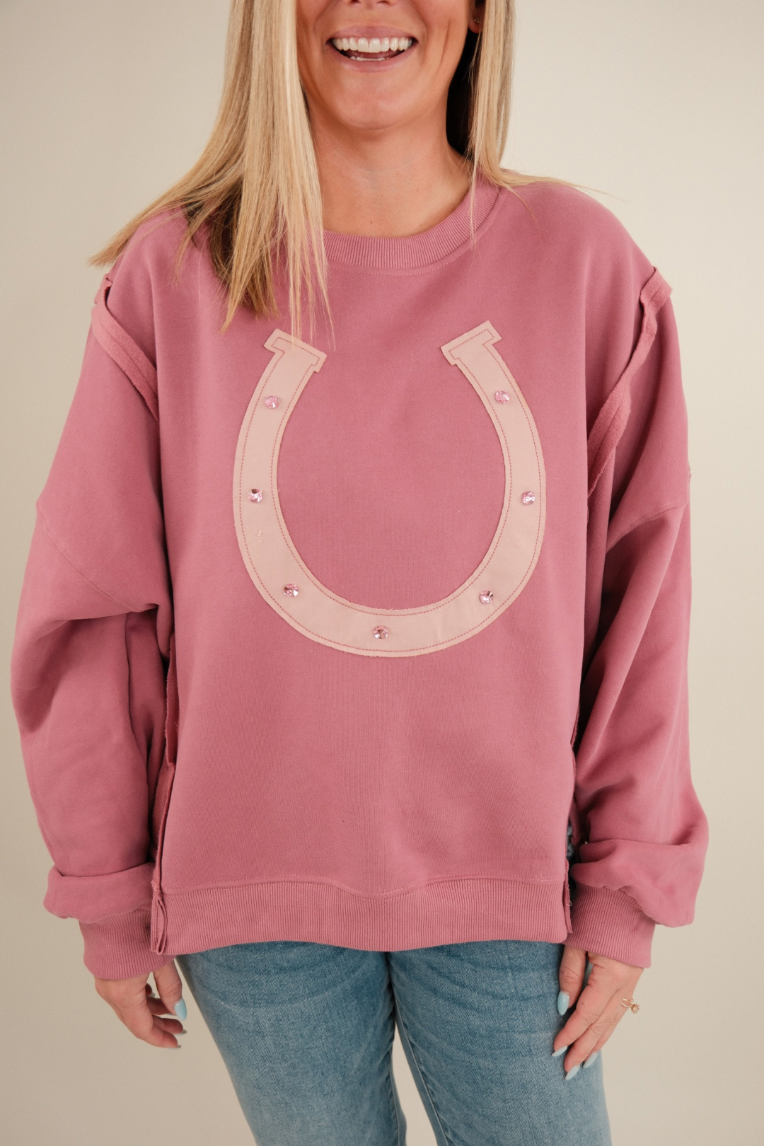 Women’s Lucky Charm Pullover, light mauve knit with cream western motifs and pink gemstone details, relaxed cowgirl fit.