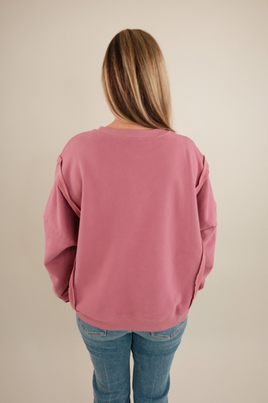 Back view of Lucky Charm Pullover in mauve with an oversized fit and slouchy arm details.