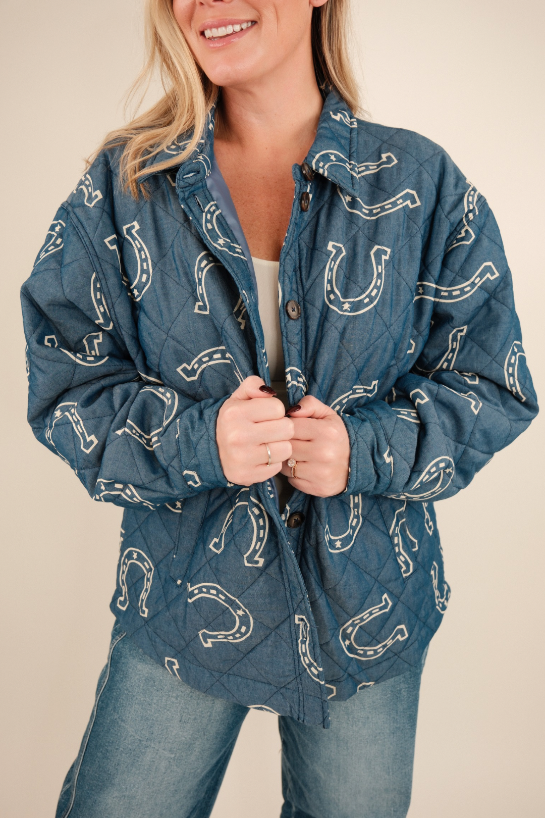 Close-up of Lucky Stitch Quilted Denim Jacket highlighting cream horseshoe print, quilted stitching, and soft textured denim fabric.