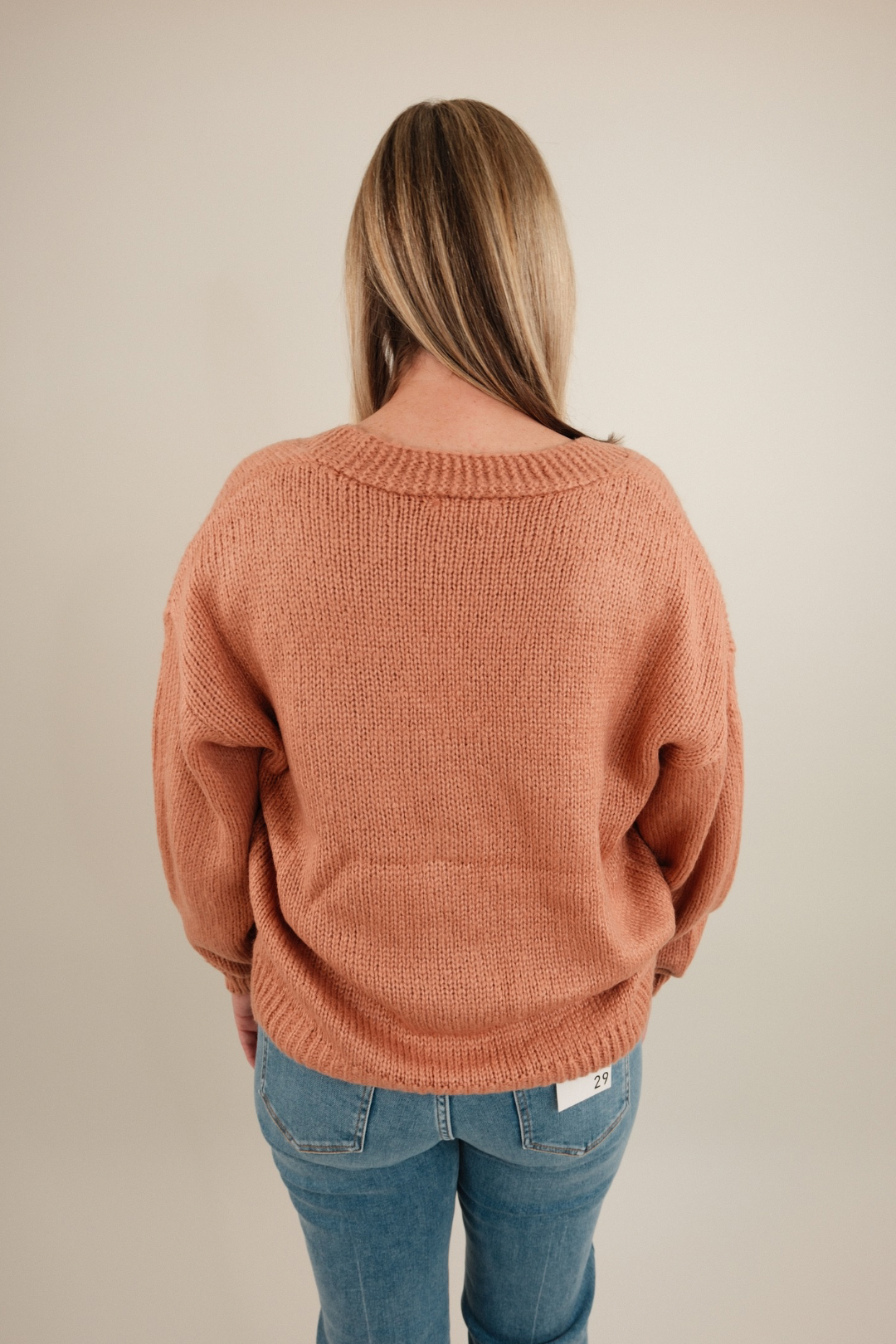 Lucky Stitches Cardigan in terra cotta showing relaxed fit, horseshoe knit pattern and cozy cowgirl layering style.