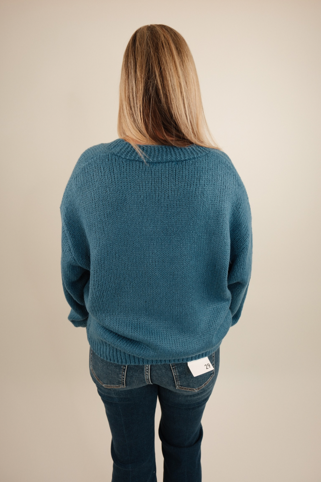 Lucky Stitches Cardigan in denim blue showing relaxed fit, horseshoe knit pattern and cozy cowgirl layering style.