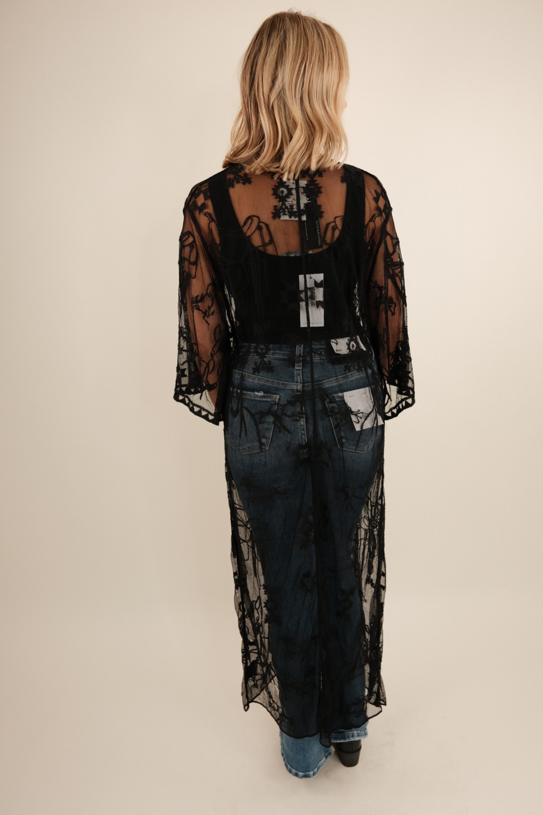 Back view of Midnight Range Mesh Duster showcasing sheer black mesh with galloping horse and saddle embroidery, frontier-inspired fit.