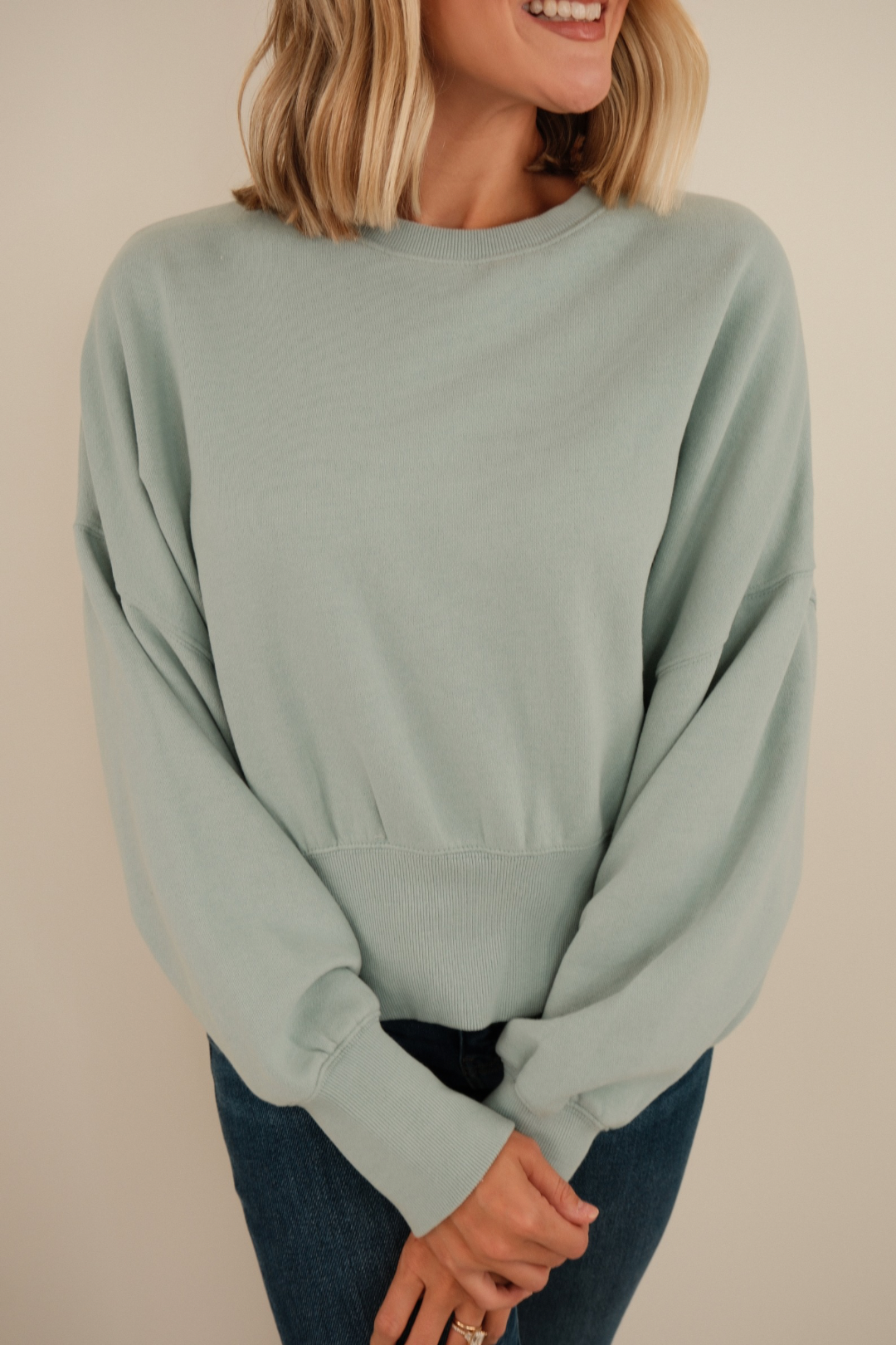 Close-up of Misty Sky Waist-Length Fleece highlighting soft brushed texture, rpunded neckline and sky-blue fabric.