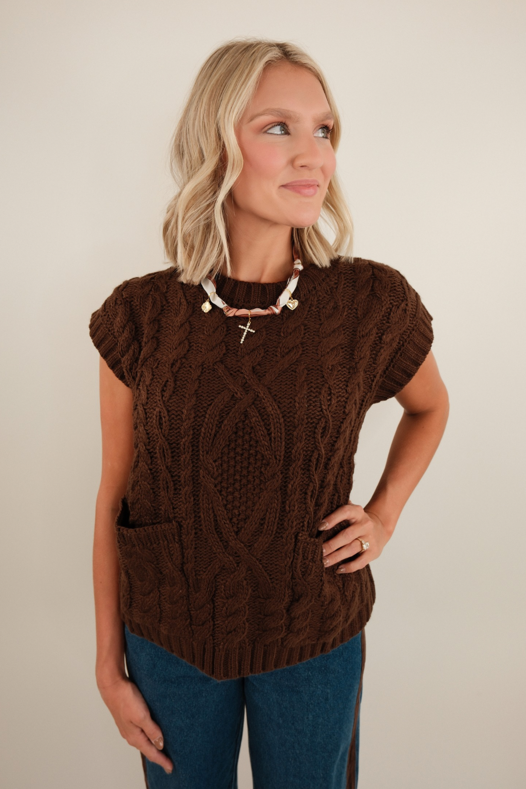 Soft mocha knit sweater with relaxed fit, ribbed cuffs & hem, v-neckline and tonal knit texture.