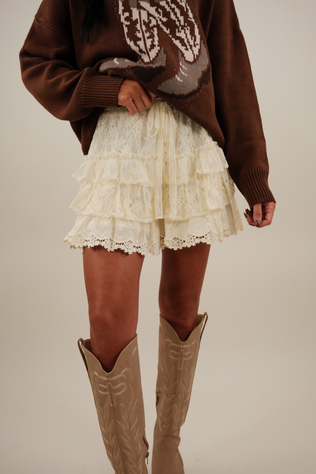 Cream tiered lace shorts with built-in liner and elastic waistband — flirty skirt illusion meets functional design.